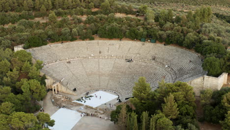 tourists visit ancient theatre of epidaurus in greece