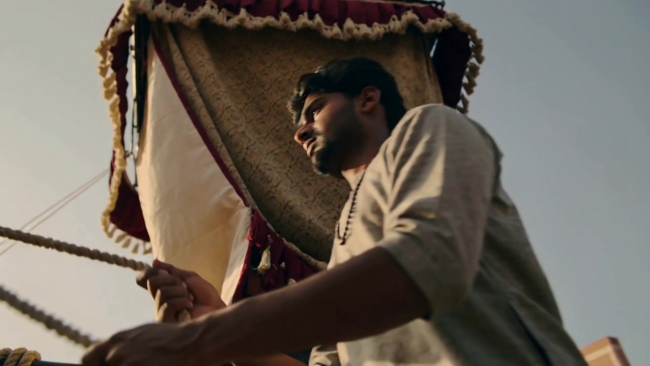 Reacting to carriage rolling, man in light tunic steadying thick ropes on street with ornate canopy