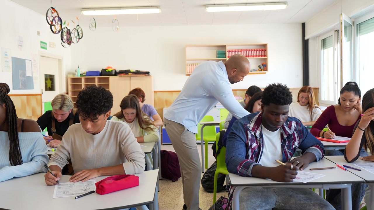 Teacher Supervising Students During Classroom Exam
