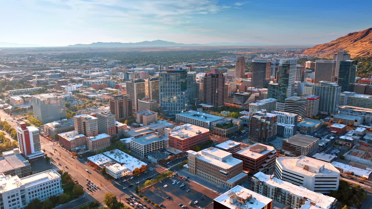 Salt Lake City USA, 1 August 2025: Salt Lake City aerial skyline at sunset with mountains. Scenic view of Salt Lake City downtown skyline with glowing sunset light and mountains in the background