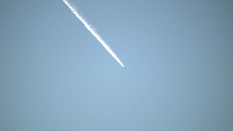 contrails of commercial aircraft against a background of blue sky