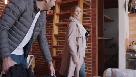 happy couple arriving in holiday home smiling enjoying cozy apartment hugging excited for travel vacation