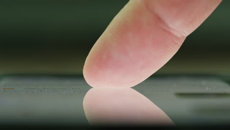 finger touching a smartphone screen