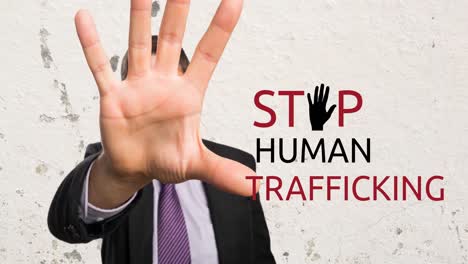 Animation-of-stop-human-trafficking-text-over-caucasian-man-with-stop-gesture