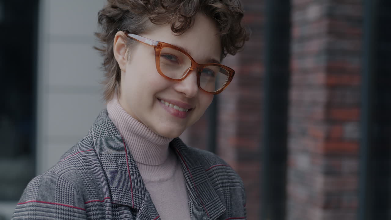 Smiling Woman in Plaid Jacket and Glasses