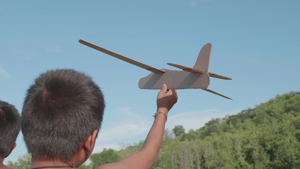 Kids Playing with Cardboard Airplane