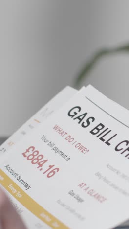 close up vertical video of person looking at overdue uk energy bills