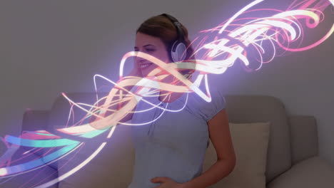 animation of neon trails over pregnant caucasian woman listening to music