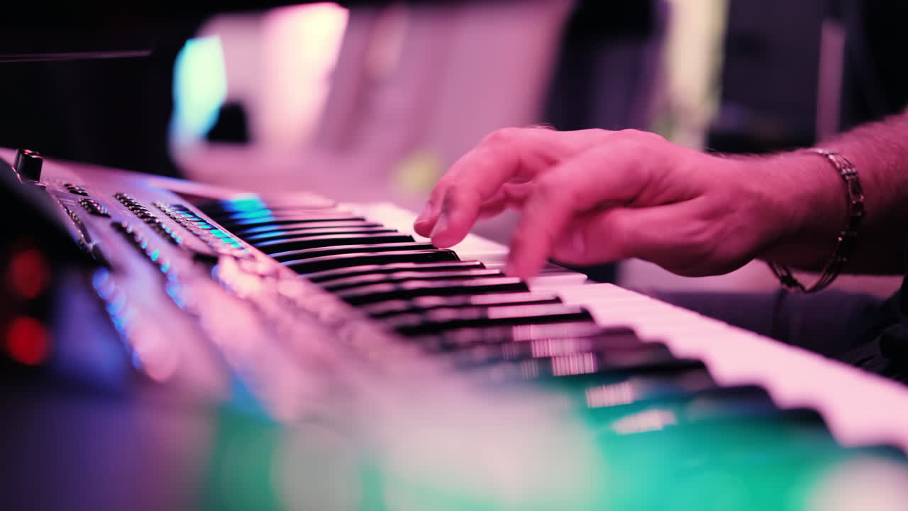 Musicians playing at a wedding. Man is playing synthesizer. Stage lights