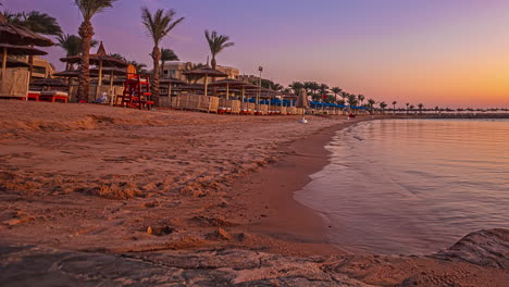 Timelapse---Beach-resort-with-chairs-and-umbrellas-at-sunset