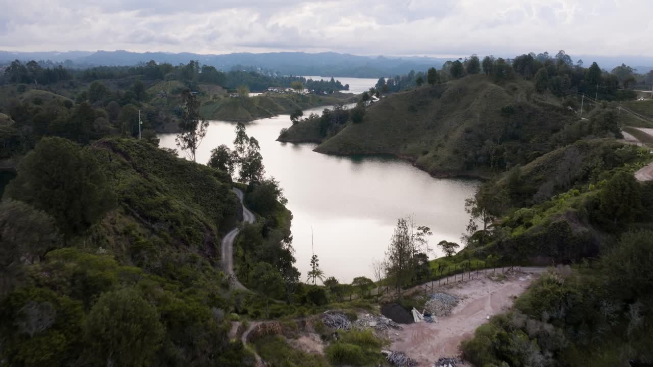 Drone shot of Guatapé (La Piedra Rock) with lakes and mountains on a cloudy day