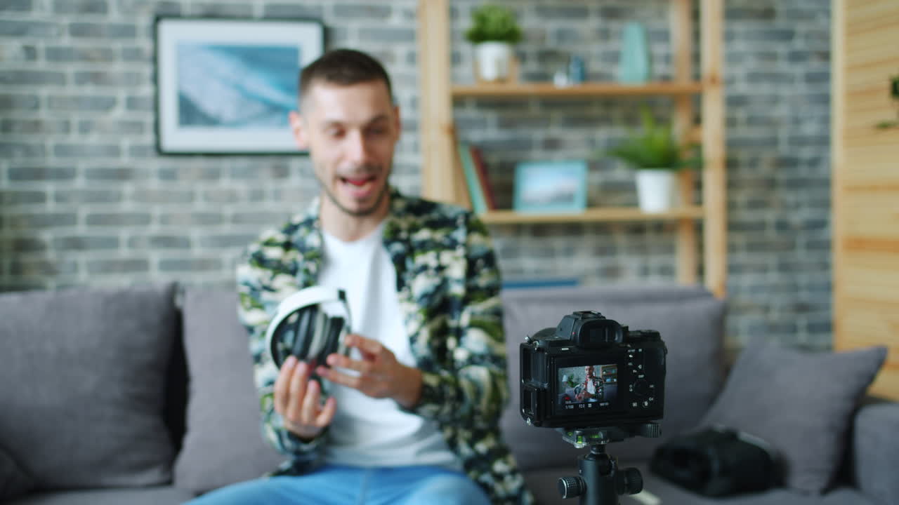 Man reviewing headphones at home