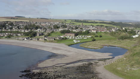 an aerial view of inverbervie looking over the town from the sea on a sunny summer's day