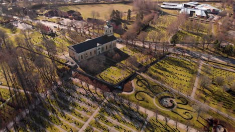 Drone-flying-towards-church-passing-graves