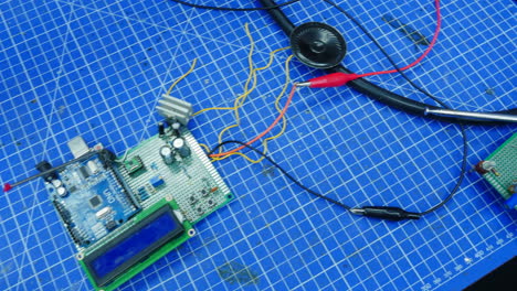 electronics project setup on a blue mat