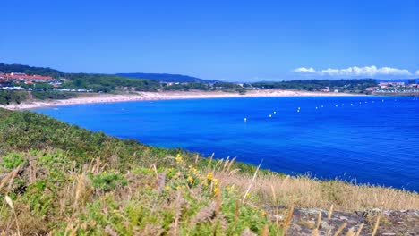 time lapse of large beach with blue water between villages in galicia spain