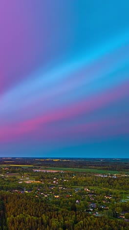 a serene landscape at sunset with a smooth gradient of colors in the sky over rural areas