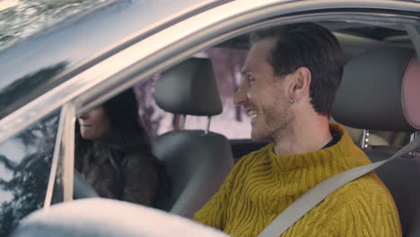 husband and wife sitting in the front seats of a car 2