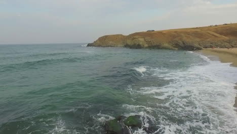 sea waves breaking into rocks