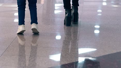 CU-Slow-motion-Young-mother-leads-a-little-daughter-by-the-hand-they-walk-along-the-business-center-Jumping