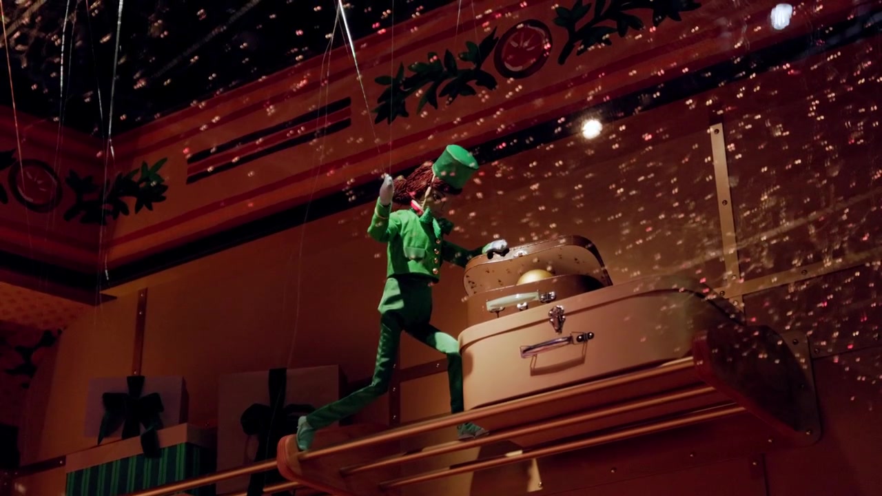 Festive Paris Christmas display with animated figure in a boutique surrounded by sparkling lights