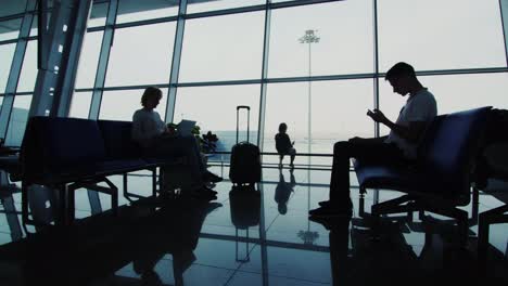 man woman and baby girl in airport waiting room