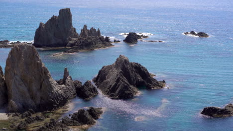 people bathing at las sirenas bay, cabo de gata, almeria. zoom out
