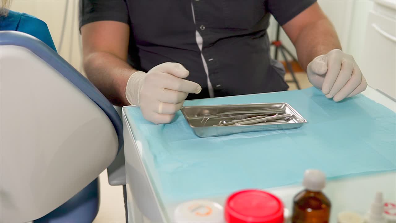 Dentist preparing for dental procedure