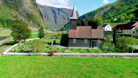 wooden exterior of flam church with graveyard in village of flam in norway