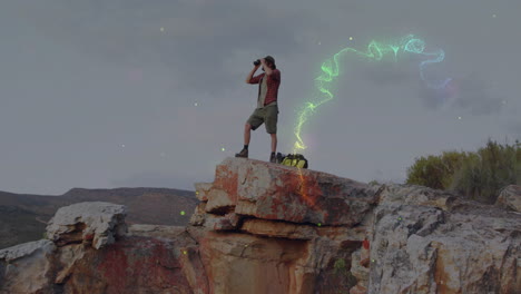 man scanning hills with binoculars from outcrop, presenting animated map overlay for education