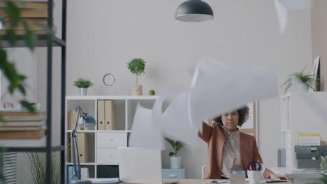 stressed worker throwing papers