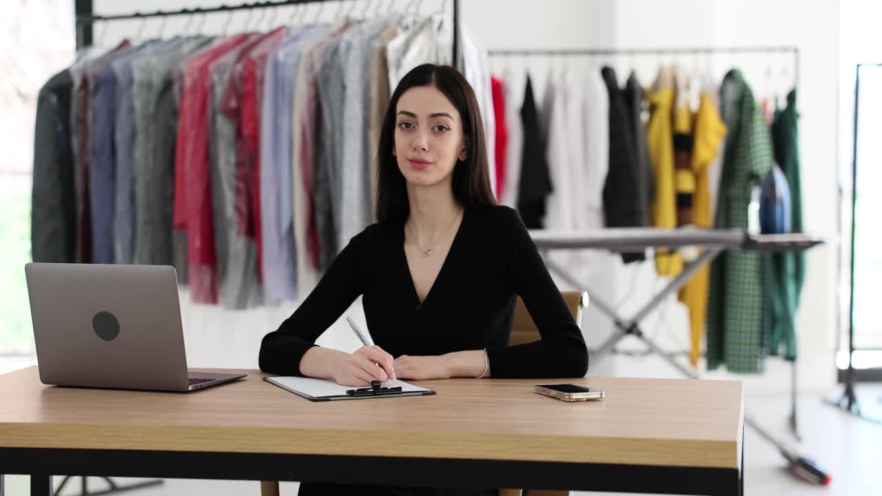 Woman working at a desk in a clothing store