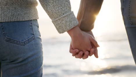 support, love and couple at the beach holding