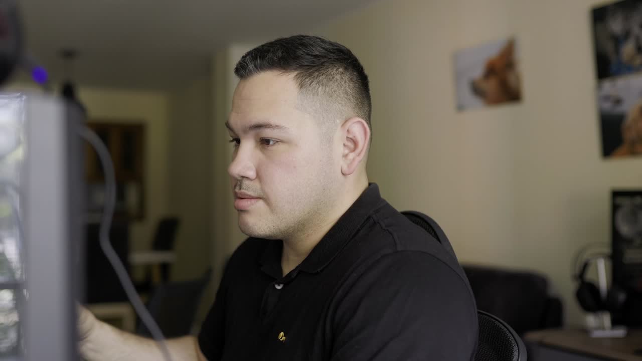 super foto apretada de un joven latino de piel blanca trabajando en una computadora de escritorio y bebiendo café