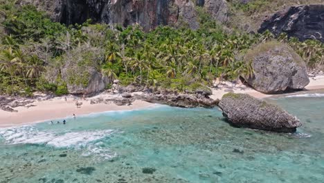 Tourists-on-Fronton-exotic-tropical-Caribbean-beach,-Las-Galeras-in-Dominican-Republic