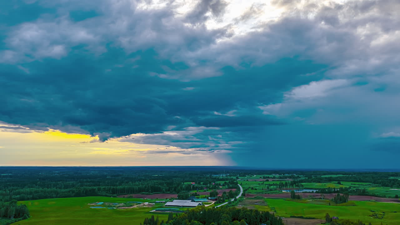 Dramatic storm cloud formation over rural farmland in aerial hyperlapse during summer