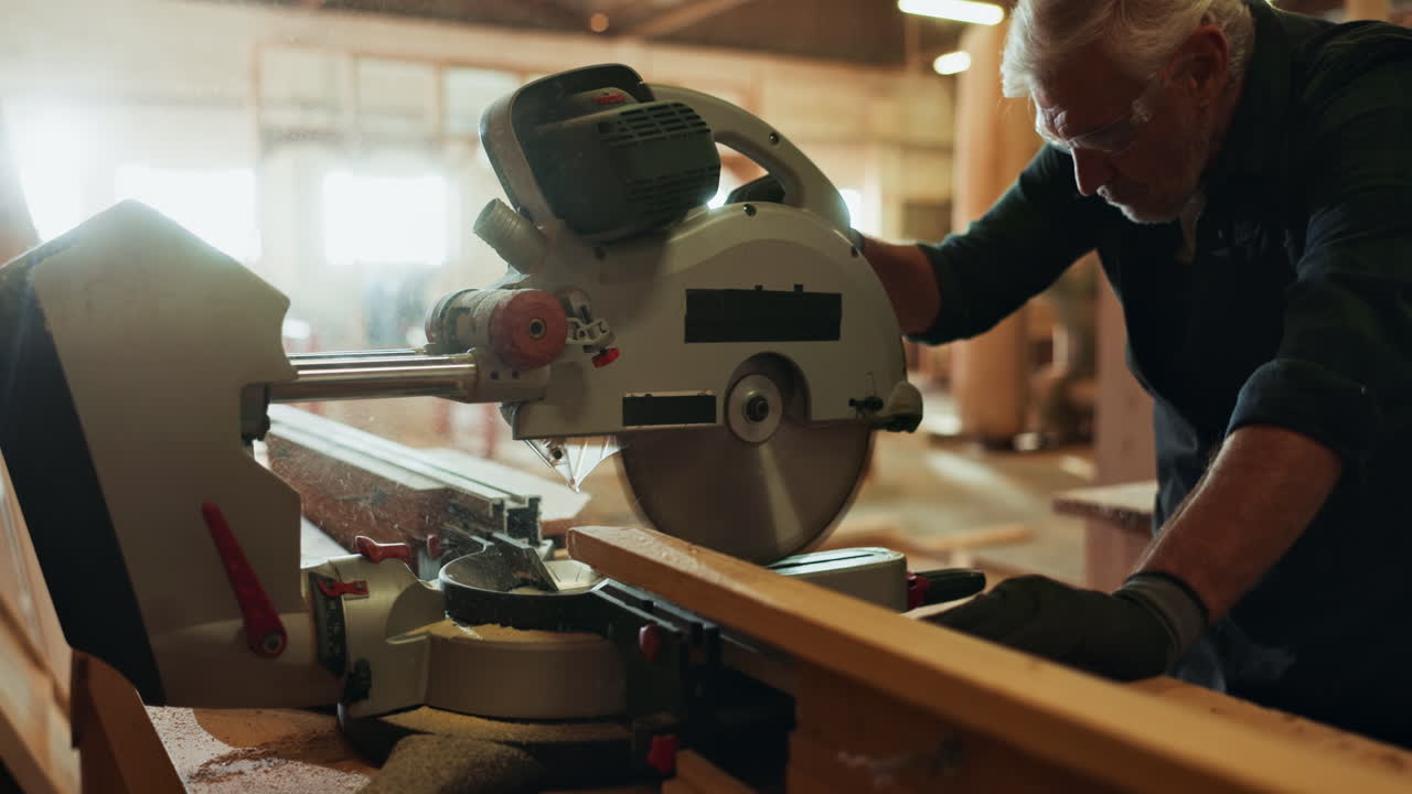 Carpenter using a miter saw