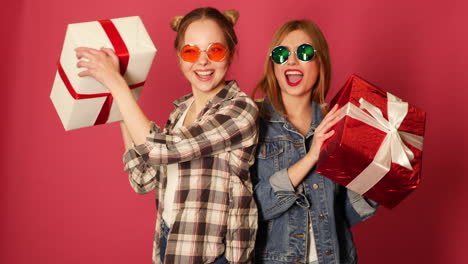 two happy friends celebrating with gifts