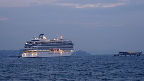 cruise ship sailing on the ocean at sunset