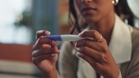 woman holding a pregnancy test