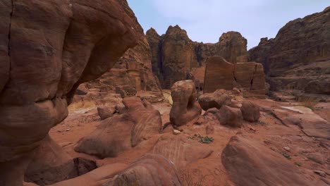 walking along tombs in petra close to the treasury, historic unesco heritage site carved into red rock sandstone in jordan. famous indiana jones movie filming location and tourist destination khaznet.