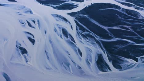 aerial top down shot of snowy markarfljót glacial river in south iceland, near seljalandsfoss during daytime