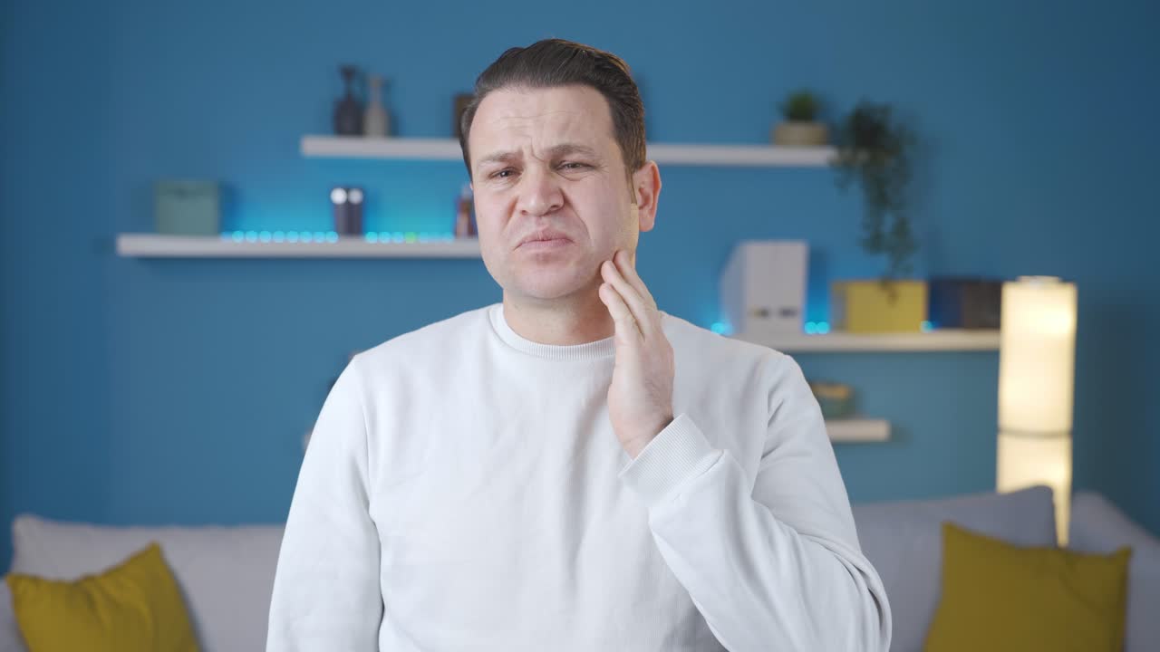hombre que sufre de dolor de muelas en casa.