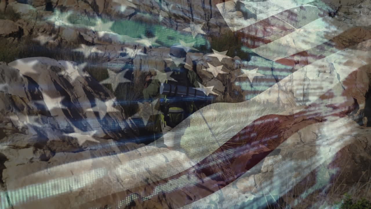 Man hiking with backpack and pole across arid canyon, featuring travel-themed American flag overlay
