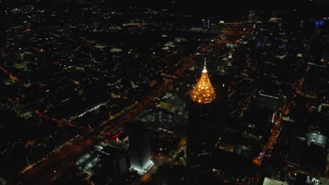 a stunning night-time aerial view over a lit downtown skyline