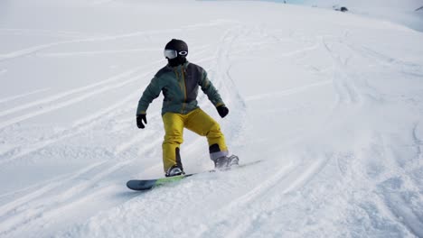 Snowboarder-making-turns-in-the-powder-snow-during-winter