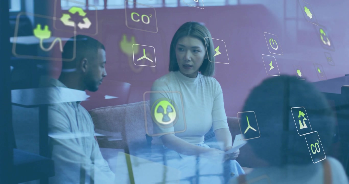 Woman in meeting looking up and talking, gesturing while energy icons moving over glass, planning