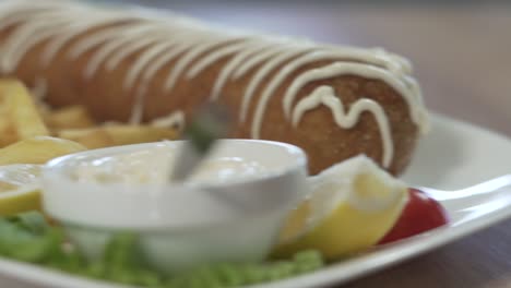 Rolled-steak,-with-French-fries-and-white-sauce-on-the-plate