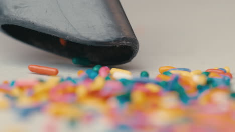 Rainbow-sprinkle-spill-being-cleaned-and-suctioned-up-with-vacuum-in-slow-motion