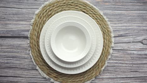 white dinnerware set on a straw placemat